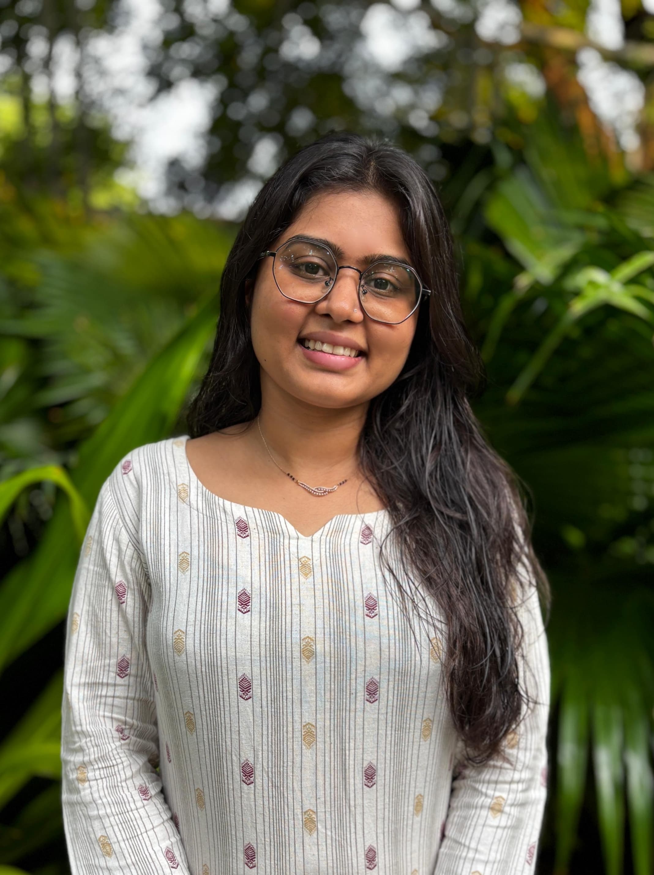 Dr. Vini Solanki, Naturopathic Doctor & Wellness Expert, smiling professionally in a clinical setting or natural environment.